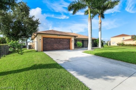 view of front facade featuring an attached garage, concrete driveway, a front yard, and fence