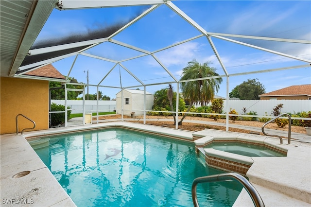 view of swimming pool with a lanai, a storage shed, an in ground hot tub, and a patio