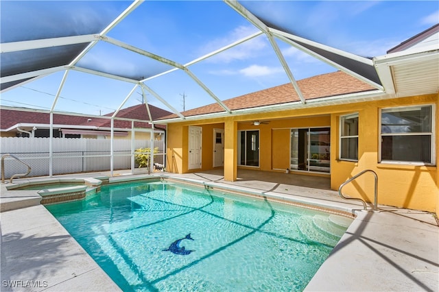 view of pool with a lanai, an in ground hot tub, and a patio area