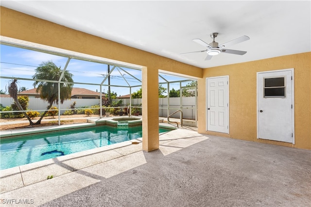 view of swimming pool with a lanai, an in ground hot tub, ceiling fan, and a patio