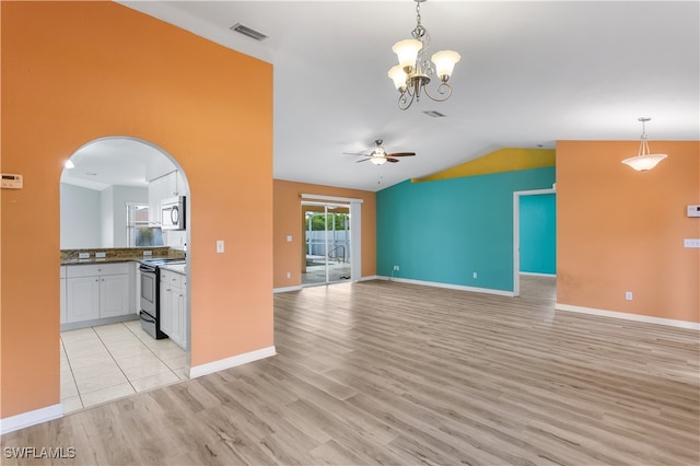 unfurnished living room with light wood-type flooring, ceiling fan with notable chandelier, and lofted ceiling