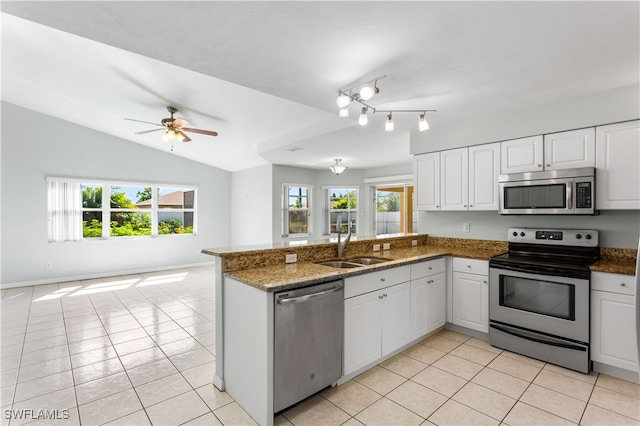 kitchen with light tile patterned floors, kitchen peninsula, ceiling fan, appliances with stainless steel finishes, and white cabinets