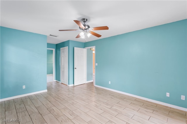 spare room featuring ceiling fan and light hardwood / wood-style floors