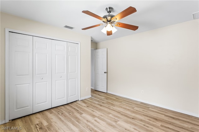 unfurnished bedroom featuring a closet, ceiling fan, and light hardwood / wood-style flooring