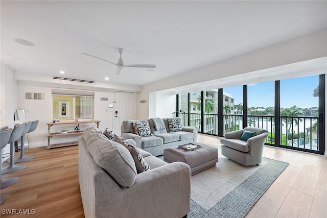 living room featuring light wood-style flooring, recessed lighting, baseboards, and ceiling fan