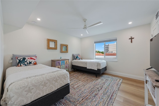 bedroom with ceiling fan and light hardwood / wood-style floors