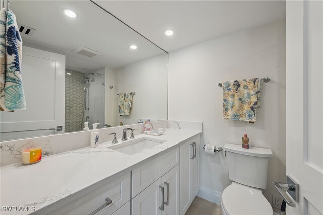 bathroom with vanity, toilet, and an enclosed shower