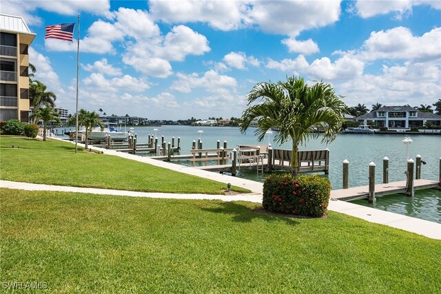 dock area featuring a water view and a yard