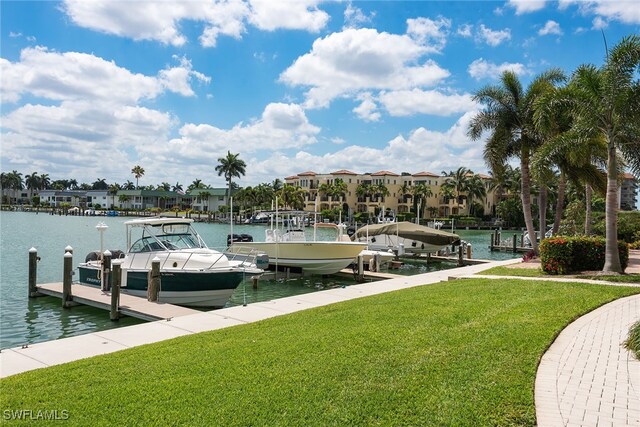 dock area with a water view and a lawn