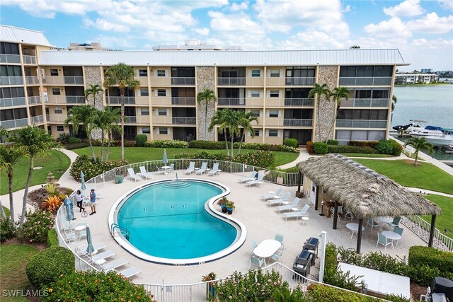 view of swimming pool with a patio and a water view