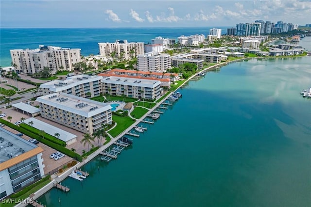 birds eye view of property with a city view and a water view