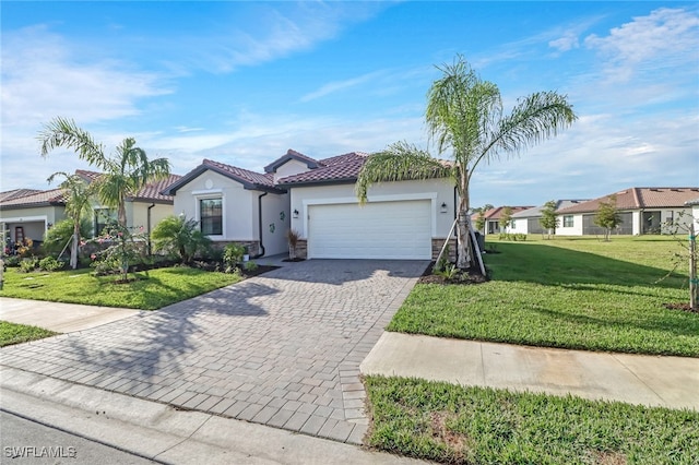 view of front of house with a garage and a front lawn