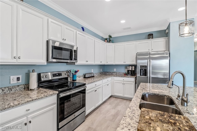 kitchen with white cabinets, sink, crown molding, and appliances with stainless steel finishes