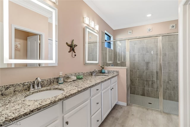 bathroom with crown molding, vanity, and an enclosed shower