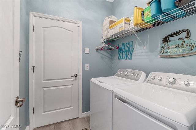 clothes washing area featuring washer and dryer and light hardwood / wood-style floors