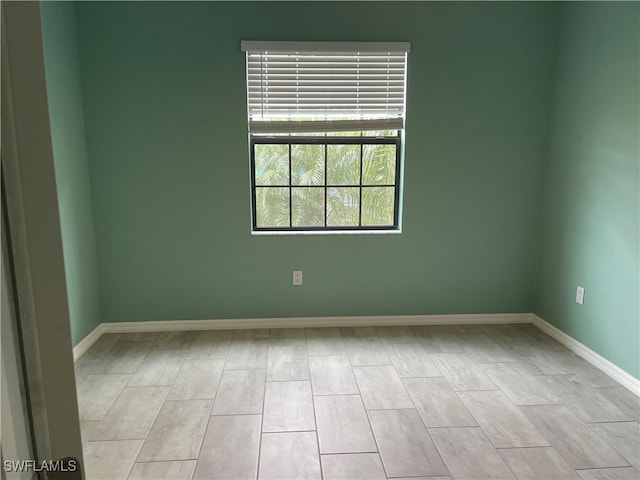 spare room with light hardwood / wood-style flooring