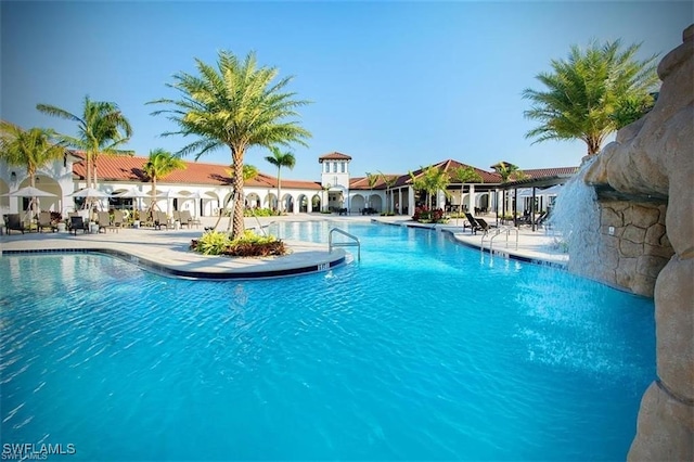 view of pool with pool water feature and a patio area