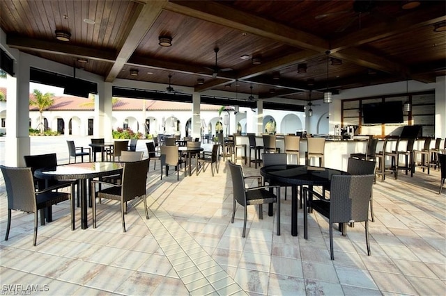 dining room with beamed ceiling and wood ceiling