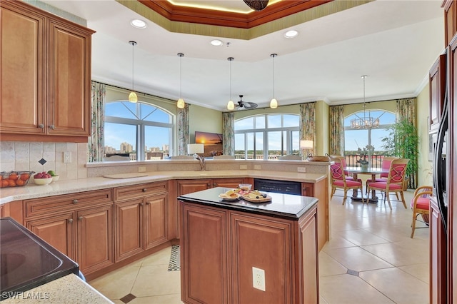 kitchen with hanging light fixtures, plenty of natural light, ornamental molding, and a kitchen island