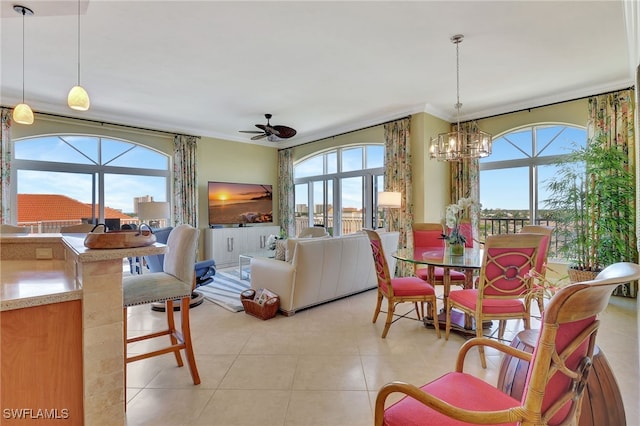 dining area with crown molding, light tile patterned floors, and ceiling fan with notable chandelier