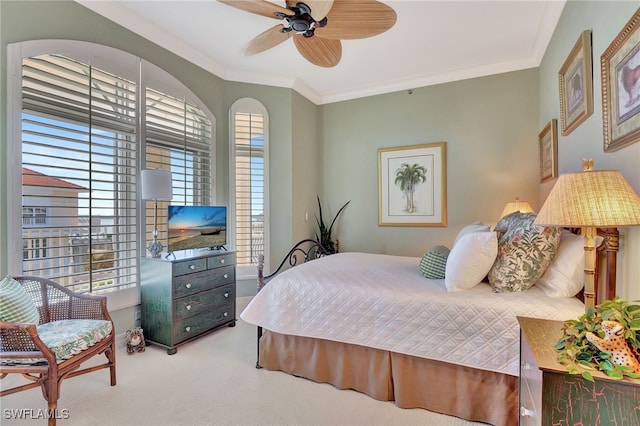 carpeted bedroom with crown molding and ceiling fan