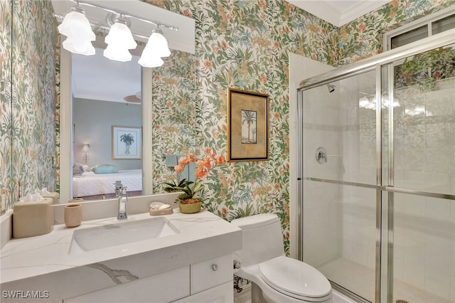 bathroom with ornamental molding, toilet, an enclosed shower, and vanity