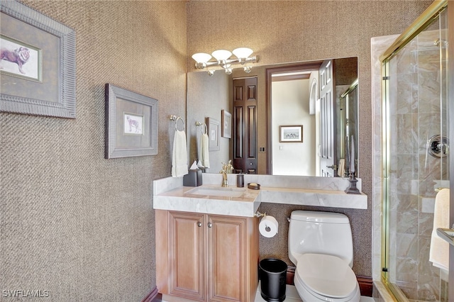 bathroom featuring vanity, a shower with shower door, and toilet