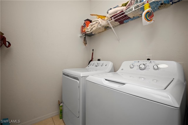 laundry room featuring light tile patterned floors and washer and dryer