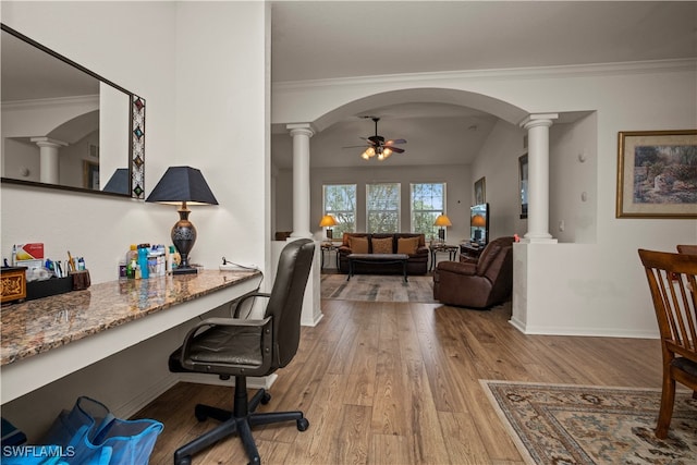 office space with ceiling fan, ornamental molding, built in desk, and light hardwood / wood-style floors