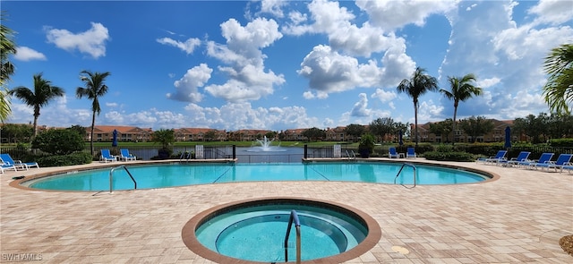 view of pool with a patio and a hot tub