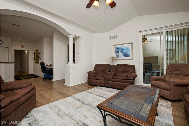 living room featuring wood-type flooring, vaulted ceiling, decorative columns, and ceiling fan