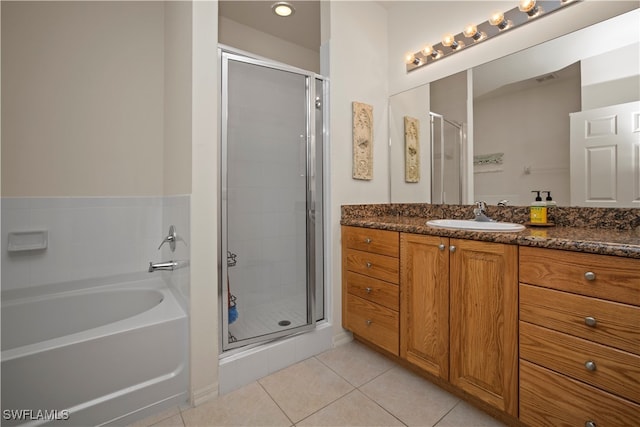 bathroom featuring independent shower and bath, tile patterned flooring, and vanity