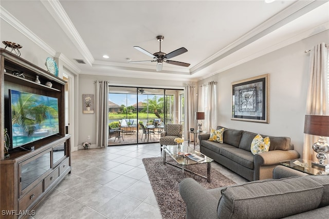 tiled living room with a tray ceiling, ceiling fan, and crown molding