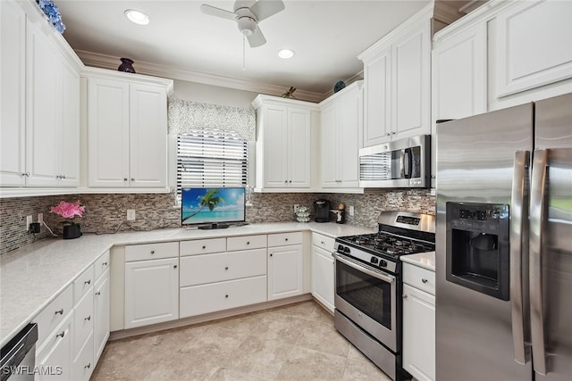 kitchen with white cabinets, appliances with stainless steel finishes, tasteful backsplash, and ceiling fan