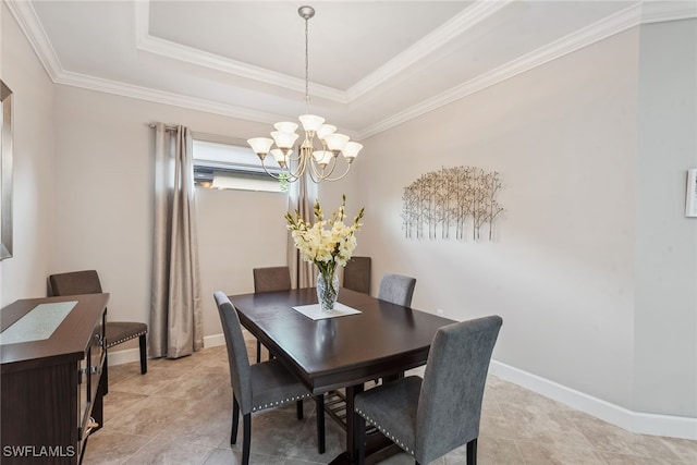 dining area featuring crown molding, a raised ceiling, and an inviting chandelier