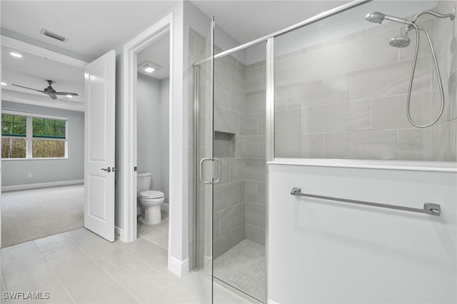 bathroom featuring walk in shower, toilet, tile patterned flooring, and ceiling fan