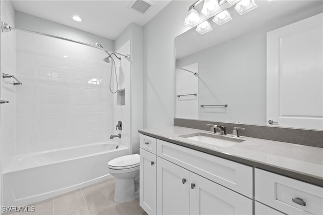 full bathroom featuring tile patterned flooring, vanity, toilet, and tiled shower / bath