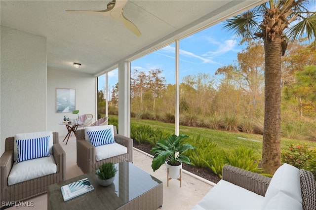 sunroom / solarium featuring ceiling fan