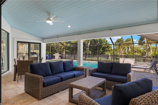 sunroom / solarium featuring ceiling fan, vaulted ceiling, and wooden ceiling