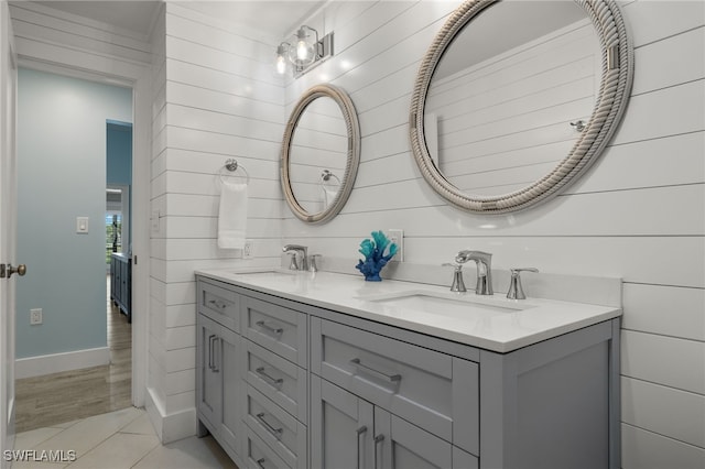 bathroom with vanity, wood walls, and hardwood / wood-style flooring