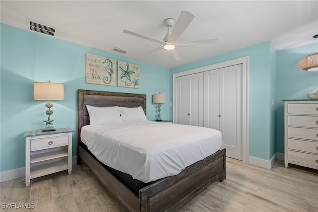 bedroom with a closet, light wood-type flooring, and ceiling fan