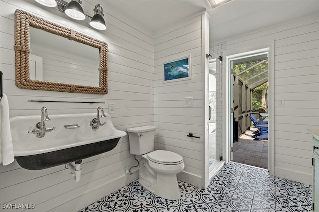 bathroom with walk in shower, tile patterned flooring, wood walls, and toilet