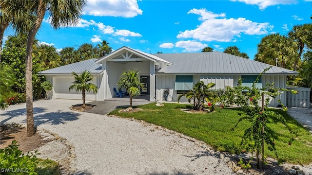 ranch-style home with a garage and a front lawn