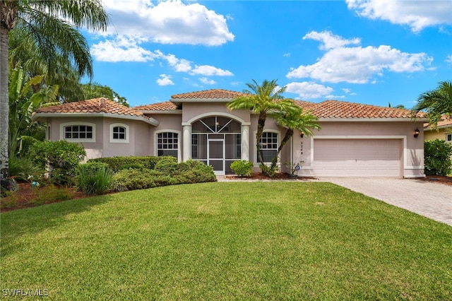 mediterranean / spanish home featuring a garage and a front lawn