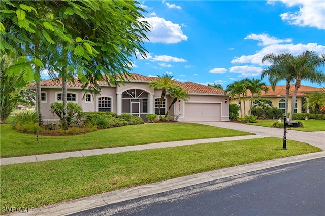 mediterranean / spanish-style home with a front yard and a garage