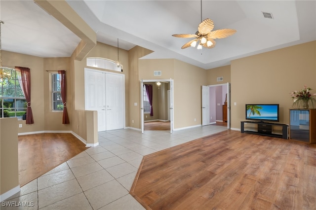 2249 Valencia Lakes Cir, Naples, FL 34120 - unfurnished living room featuring tile patterned floors, a ceiling fan, a chandelier, and baseboards