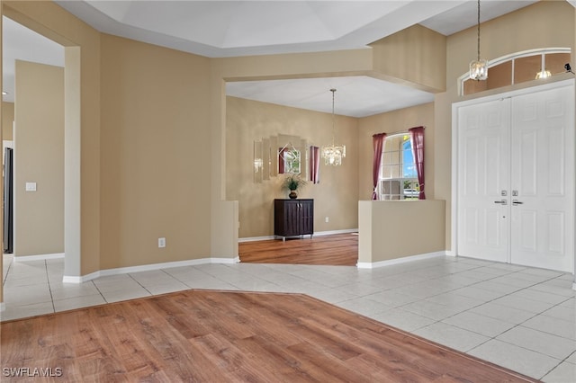 2249 Valencia Lakes Cir, Naples, FL 34120 - entrance foyer featuring a chandelier, light tile patterned flooring, and baseboards