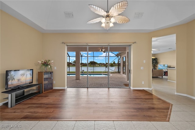 2249 Valencia Lakes Cir, Naples, FL 34120 - unfurnished dining area featuring a ceiling fan, tile patterned floors, a sunroom, and baseboards