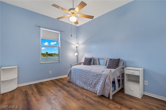 bedroom featuring ceiling fan and dark hardwood / wood-style flooring