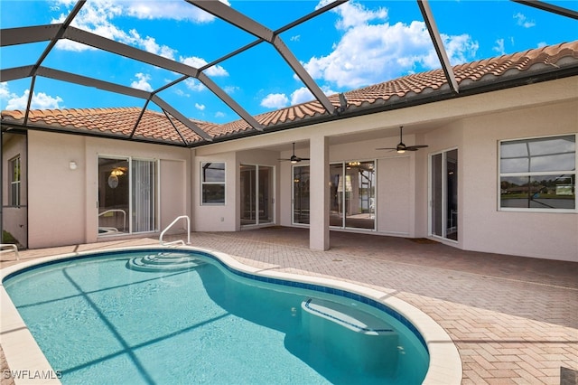 view of swimming pool featuring a lanai, a patio, and ceiling fan